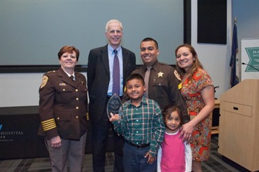 Photo with Deputy of the Year Jose Quiroz and family with County Manager Mark Schwartz and Sheriff Beth Arthur