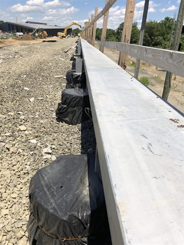 Steel channel edge installation along the top of the Esplanade.