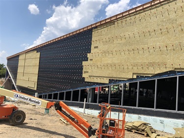 Wall system installation (wall clips) and insulation being installed on the south side of the building.