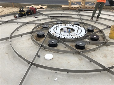 Installation for the dissolving column art work steel support base plate ring, electrical lighting and terrazzo framing.