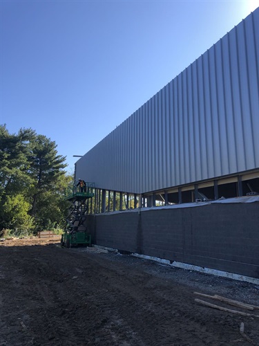 Standing metal seam siding installed on the North side of the building.