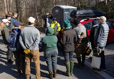 Volunteers gather around County staff next to Gulf Branch