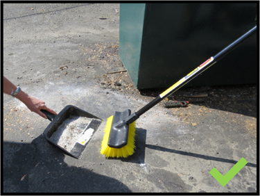 Sweeping up around a dumpster