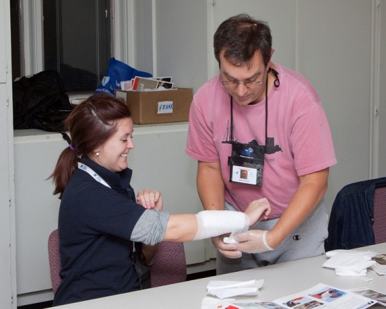 Person's arm being wrapped with bandage