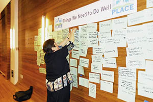 Person pinning paper on notice board