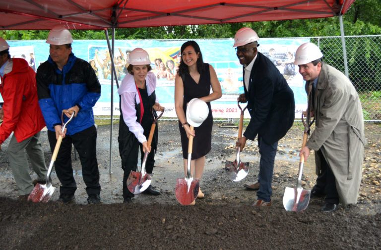 Group of people with shovels breaking ground