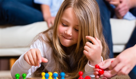 young girl playing board game