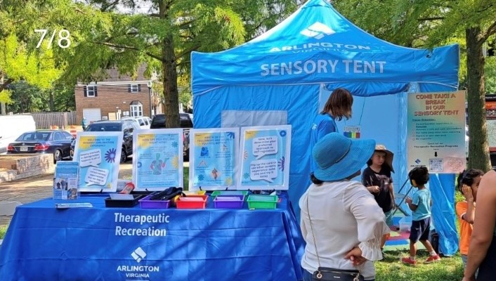 Image fair goers interacting with the sensory tent and sensory exploration experience