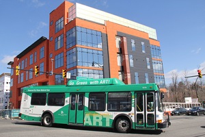 Photo with bus in foreground and building in background