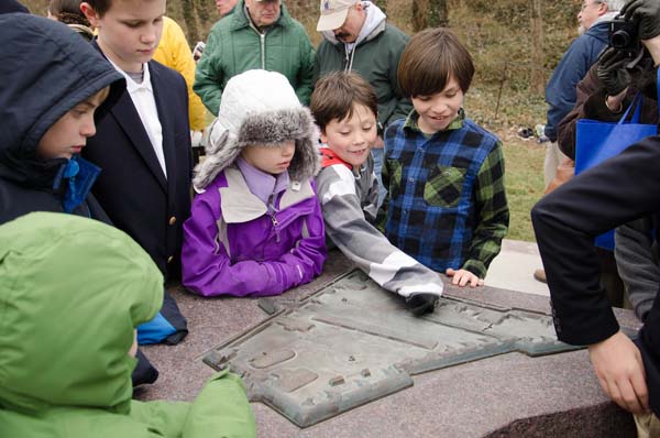 Children using the new interpretive signs to learn about the layout of Fort Ethan Allen