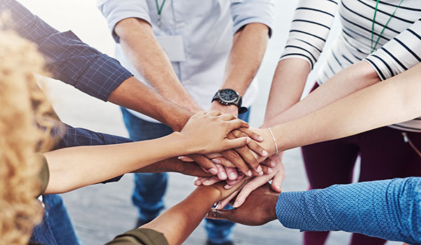 Group of peoples hands meeting in middle