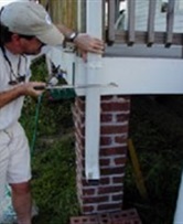 Photo showing space with downspout before a rain barrel was installed